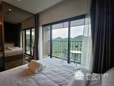 Luxurious bedroom with stunning mountain view from private balcony in modern apartment