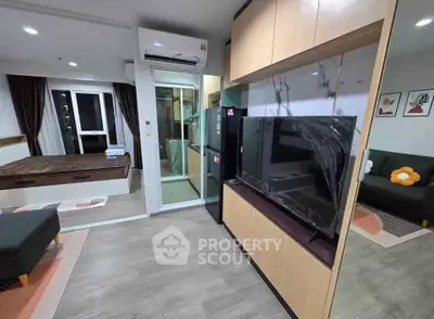 Modern studio apartment with open layout, featuring a cozy living area and stylish kitchen.