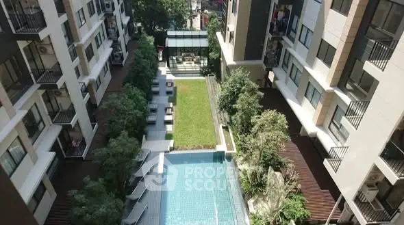 Luxurious apartment complex with pool and garden view