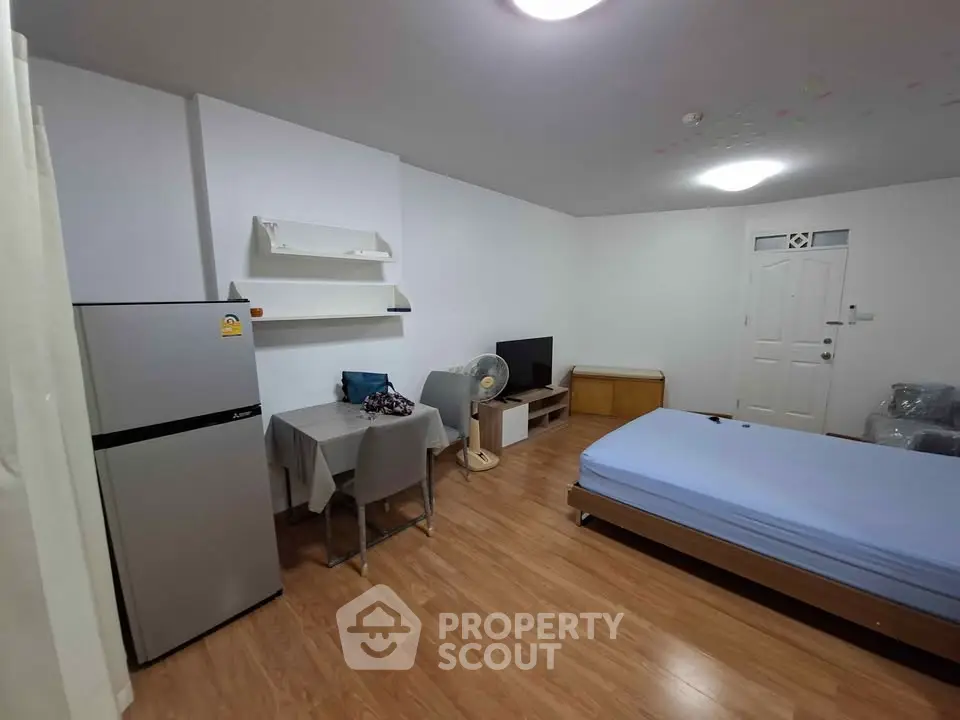 Cozy studio apartment with modern furnishings and wooden flooring