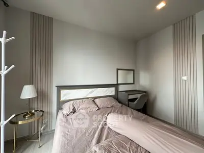 Modern bedroom with stylish decor and cozy ambiance, featuring a comfortable bed and elegant furnishings.