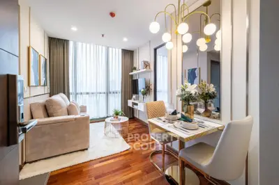 Modern living room with elegant decor and large windows in a stylish apartment.
