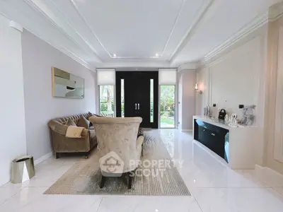 Luxurious living room with elegant furniture and large windows offering natural light.