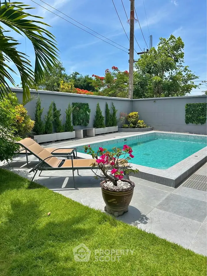Luxurious outdoor pool area with lush greenery and modern design