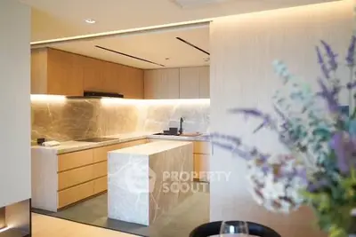 Luxurious modern kitchen with marble island and sleek wooden cabinetry