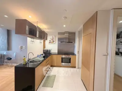 Modern kitchen with sleek cabinetry and built-in appliances in a stylish apartment.