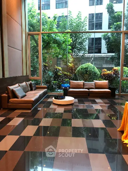 Luxurious lobby with modern seating and garden view in upscale building