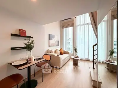 Modern living room with high ceilings and large windows offering city views.