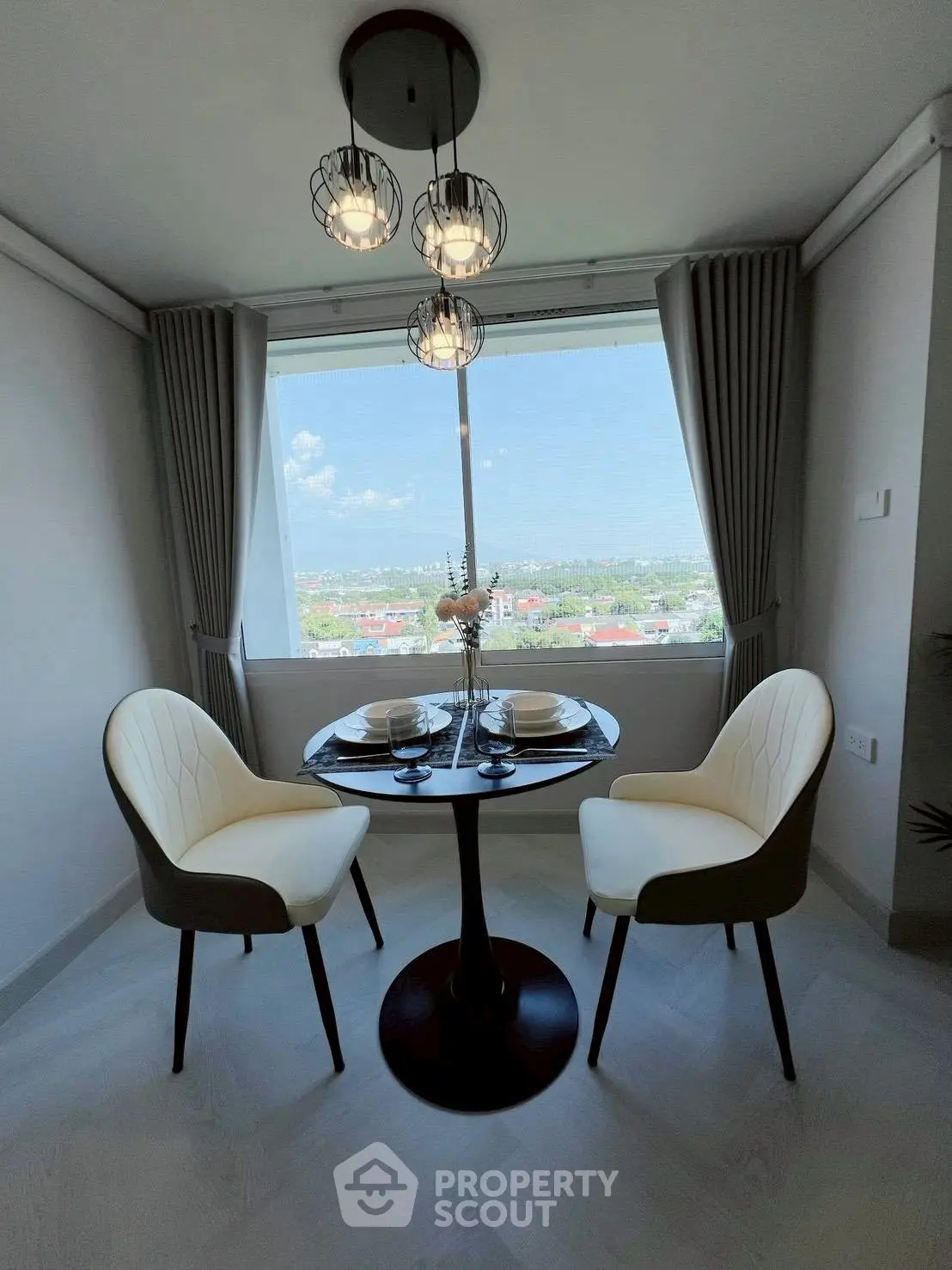 Chic dining nook with panoramic view and elegant lighting, perfect for intimate meals.