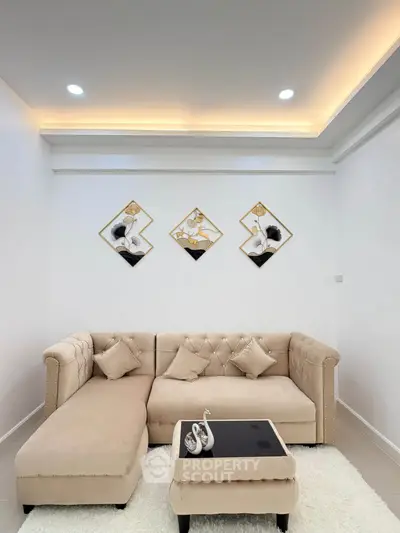 Elegant living room with plush beige sectional sofa and modern art decor