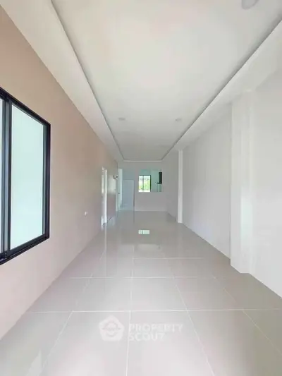 Spacious open-plan interior with sleek tile flooring and modern design, perfect for customization.