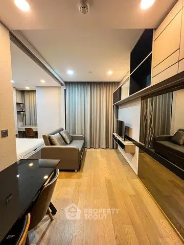 Modern living room with sleek design and cozy ambiance, featuring a stylish sofa and elegant wooden flooring.