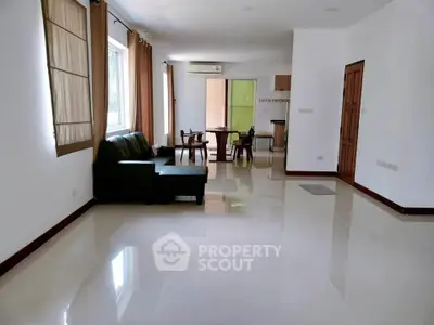 Spacious living room with modern furniture and open kitchen layout