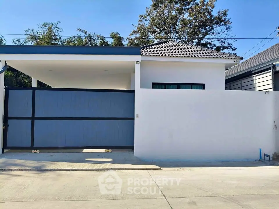Modern single-story house with gated entrance and minimalist design