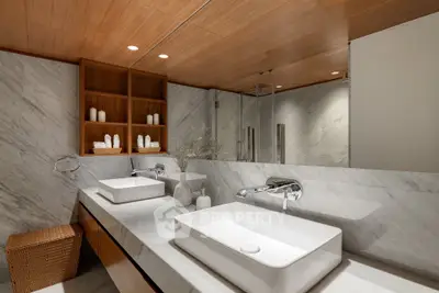 Luxurious modern bathroom with dual sinks and elegant marble finishes.