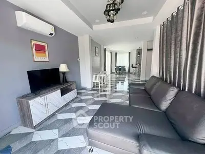 Spacious modern living room with stylish decor and ample natural light.