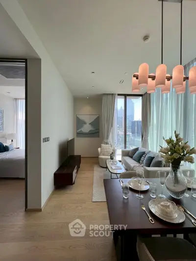 Luxurious open-plan living and dining area with city view, elegant decor, and modern furnishings.
