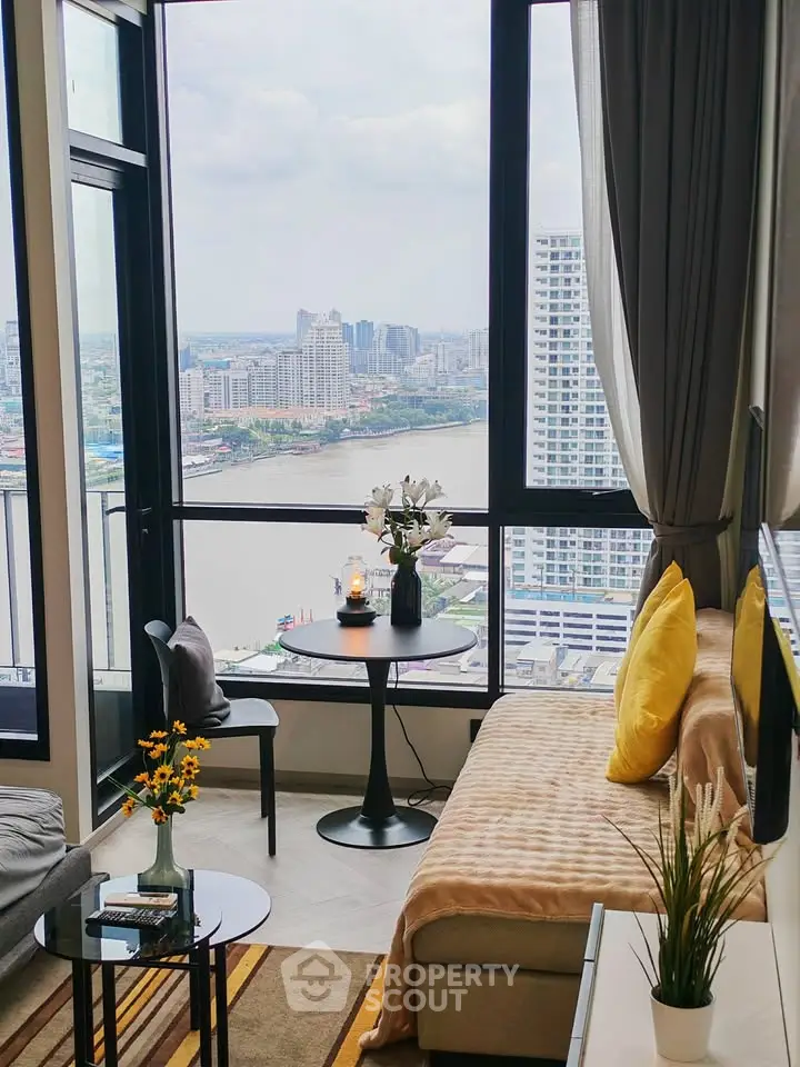 Stunning living room with panoramic city and river views, featuring cozy seating and elegant decor.