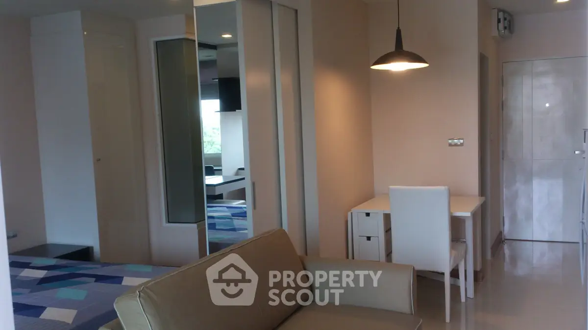 Modern studio apartment with stylish decor and cozy seating area