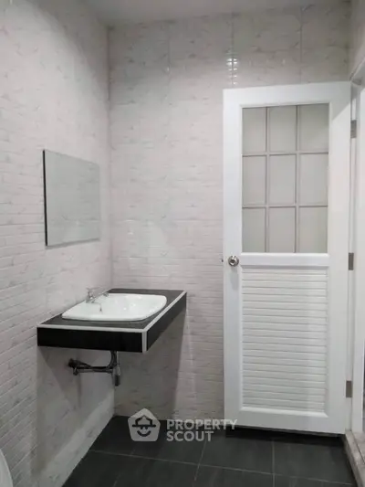 Modern bathroom with sleek sink and stylish door design
