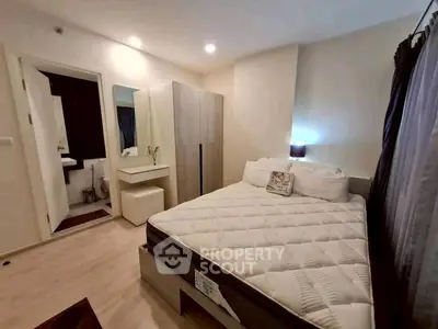 Cozy bedroom with modern decor and ample storage in a stylish apartment.