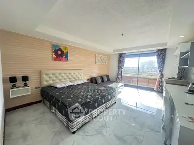 Spacious bedroom with balcony and modern decor in urban apartment
