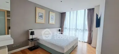 Spacious modern bedroom with large window and elegant decor