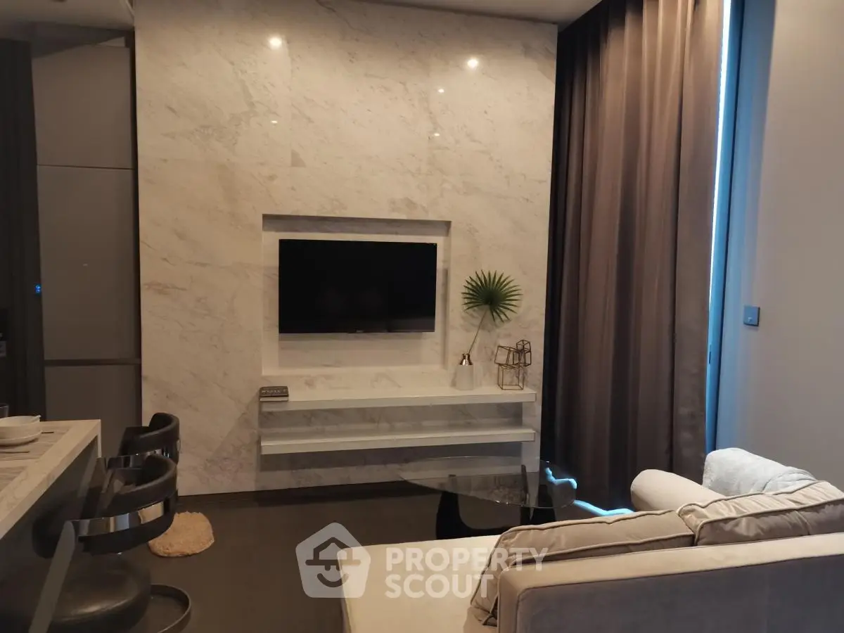 Modern living room with marble accent wall and sleek furniture