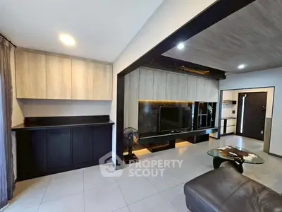 Modern living room with sleek cabinetry and stylish decor