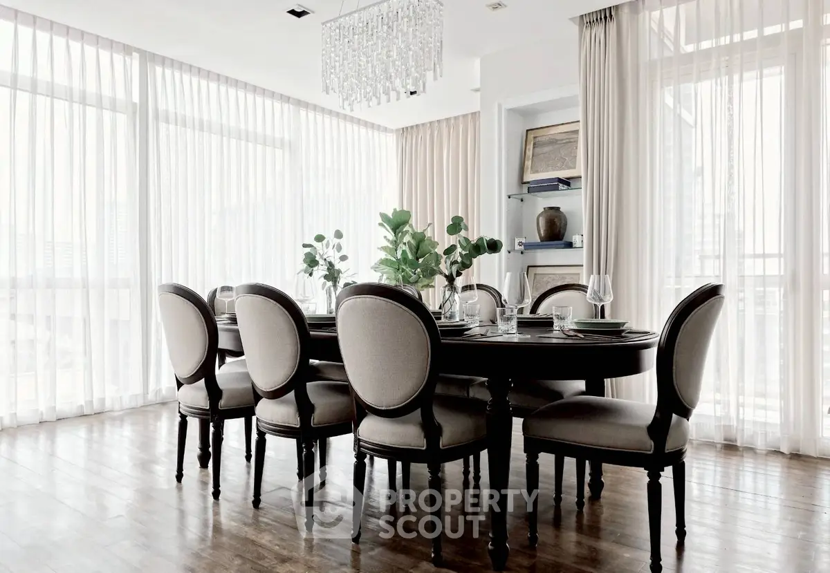Elegant dining room with large windows and classic furniture, perfect for entertaining in style.