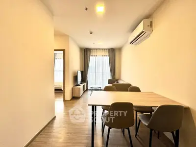 Modern living room with dining area and natural light