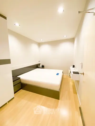 Modern minimalist bedroom with sleek design and ample lighting