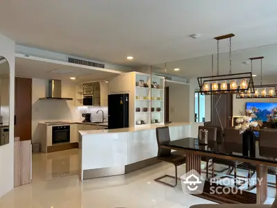 Luxurious open-plan kitchen and dining area with modern appliances and elegant lighting