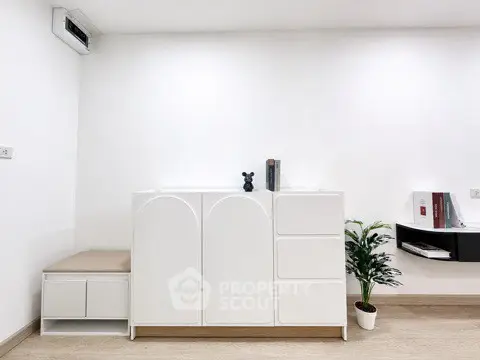 Modern minimalist interior with sleek white storage and decor