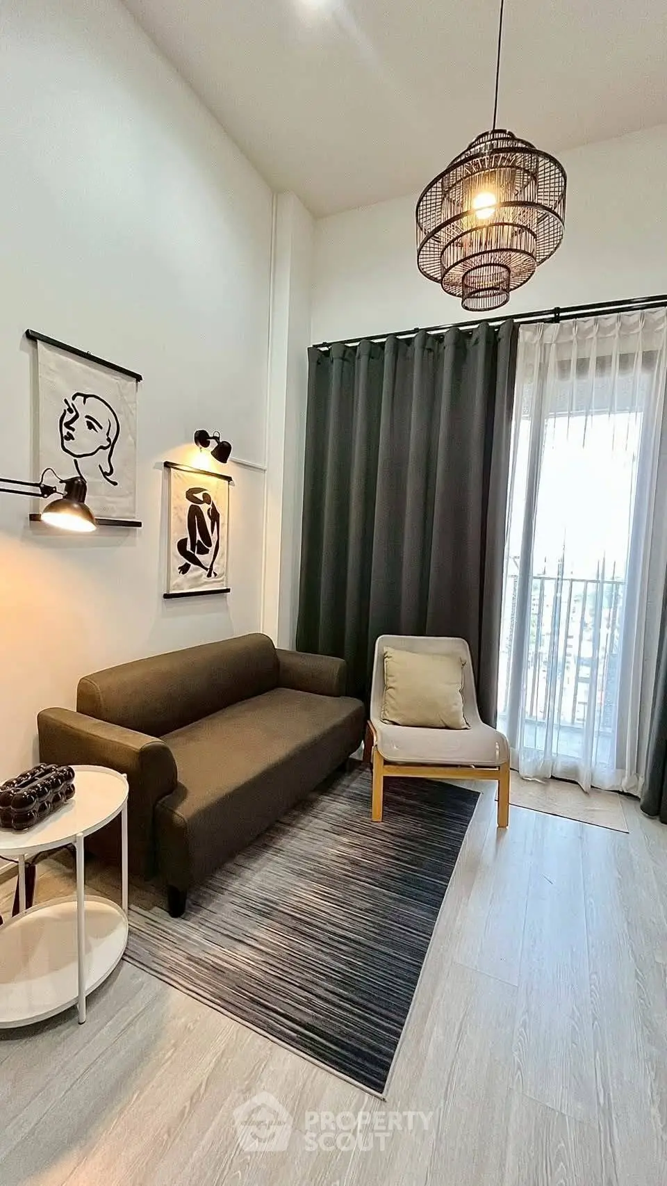 Stylish living room with modern decor, featuring a cozy sofa, elegant lighting, and a balcony view.