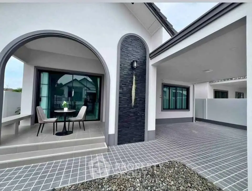Modern single-story house with stylish exterior and cozy patio area.