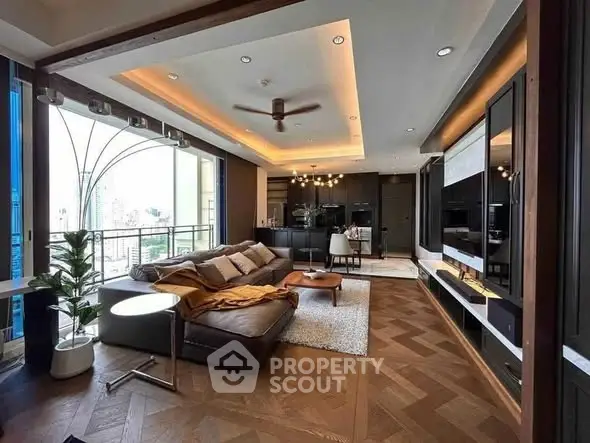 Luxurious modern living room with large windows and elegant decor in a high-rise apartment.