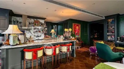 Luxurious eclectic living room with stylish bar and vibrant decor