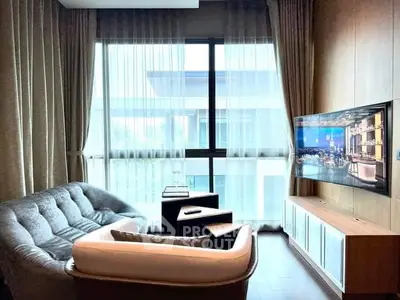 Modern living room with cozy seating and large window view