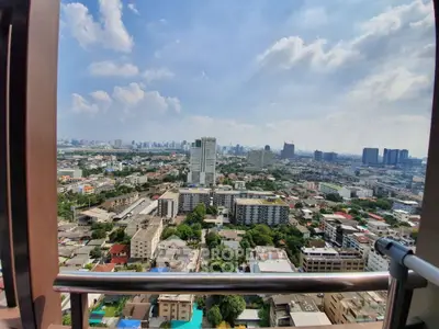 Stunning cityscape view from high-rise balcony showcasing urban skyline and vibrant neighborhood.