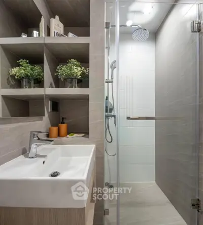 Modern bathroom with sleek shower and stylish sink in contemporary design.