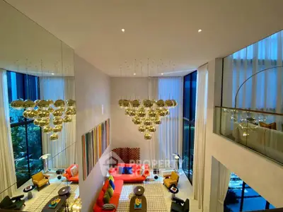 Luxurious modern living room with high ceilings, elegant lighting, and vibrant decor in a stylish apartment.