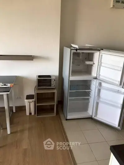 Modern kitchen with fridge and oven in a cozy apartment