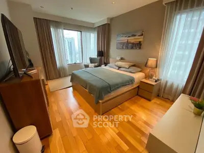 Luxurious bedroom with city view, hardwood floors, and elegant decor