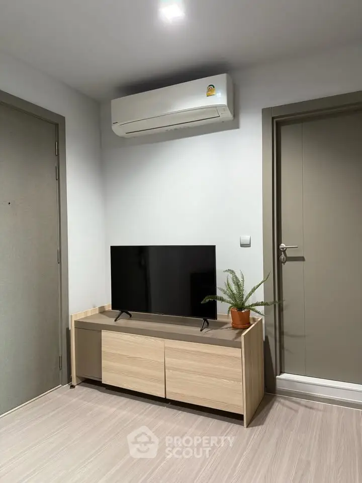 Modern living room with sleek TV stand and air conditioning unit
