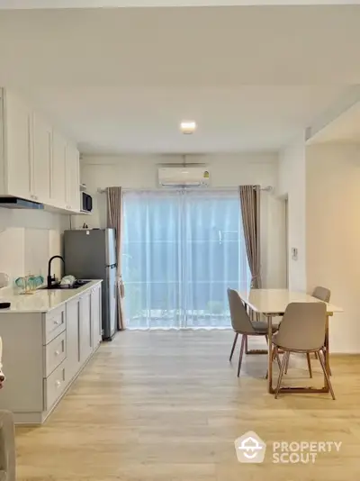 Bright modern kitchen with dining area and large window