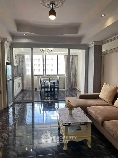 Spacious living room with elegant decor and large windows for natural light.