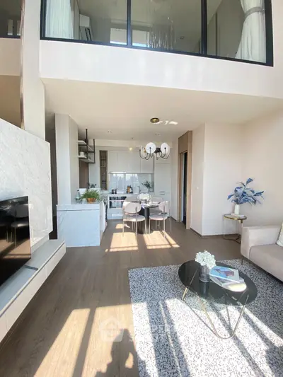 Modern open-plan living room with high ceiling and stylish decor