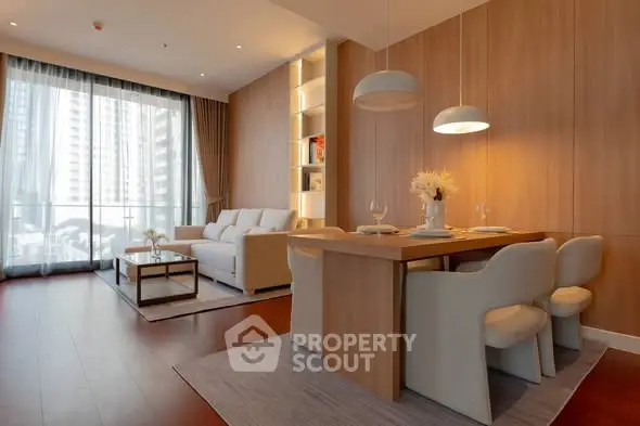 Modern living room with elegant dining area and large windows in a stylish apartment.