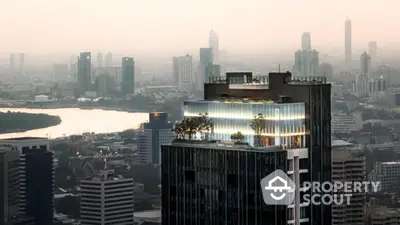 Stunning cityscape view with modern high-rise building and rooftop garden at sunset.